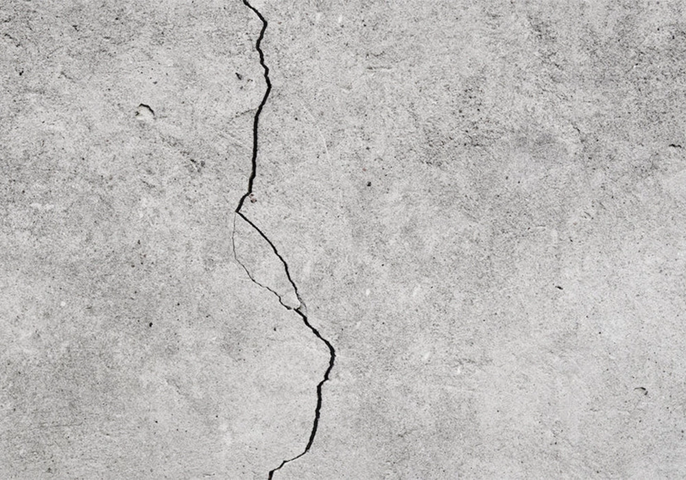 Cracked concrete surface requiring professional repair