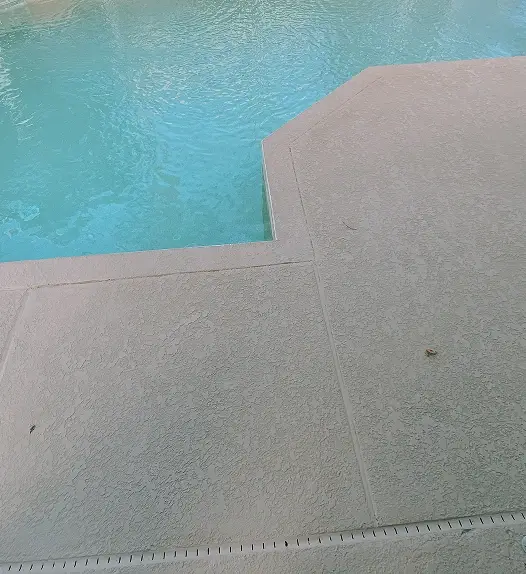 Custom pool deck installation around residential pool