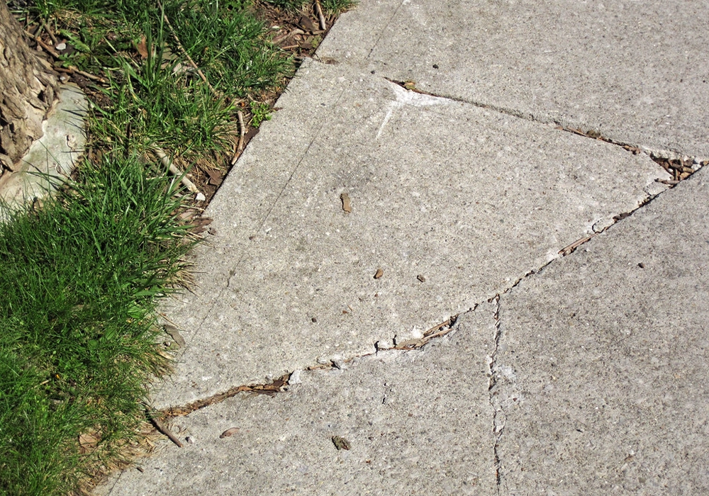 Damaged walkway concrete needing professional repair